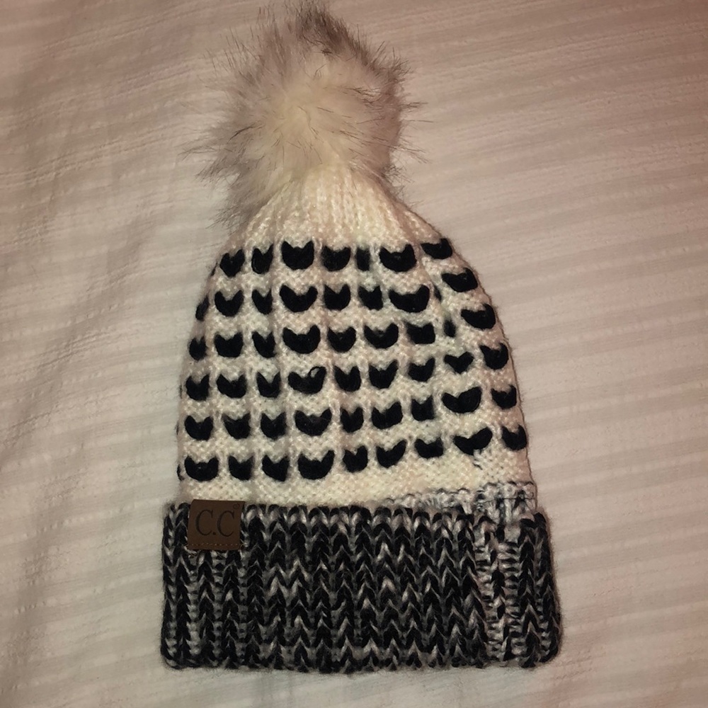 white and black puff ball winter hat